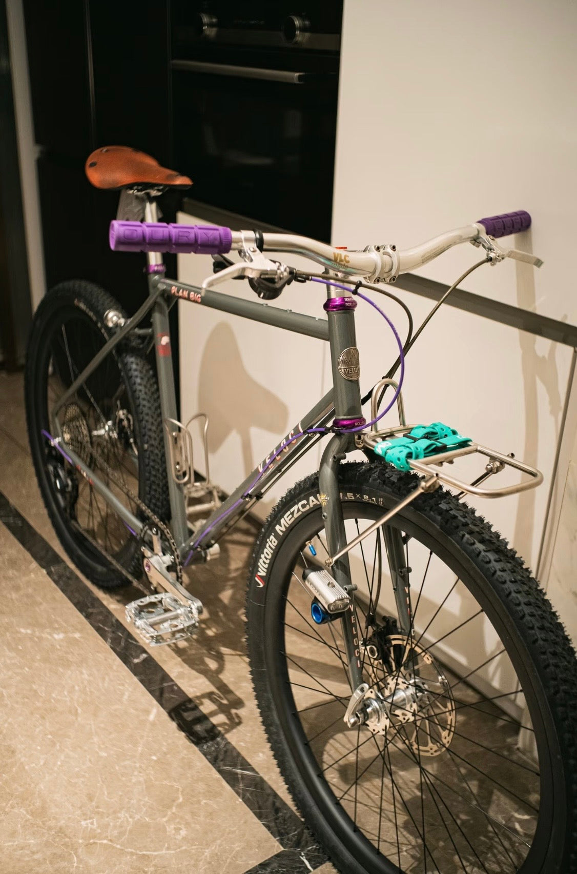 VLCmade Open Bar installed on a bicycle with purple grips, angled view