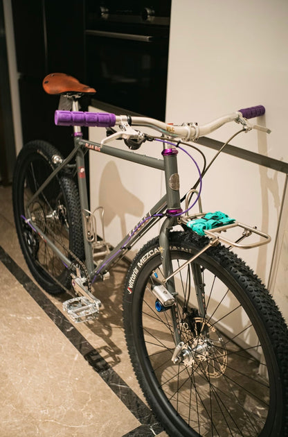 VLCmade Open Bar installed on a bicycle with purple grips, angled view