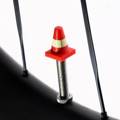 Tiny Detour Road Cone valve cap installed on a bicycle wheel