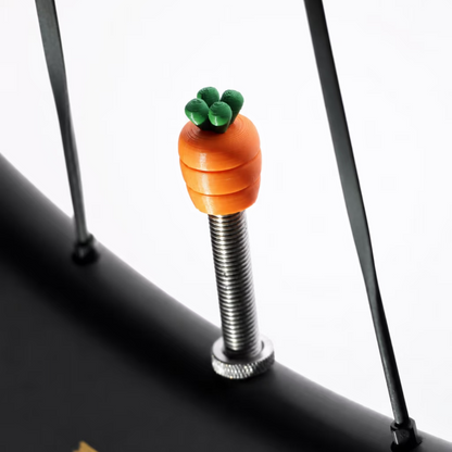 Tiny Detour Carrot Dash valve cap installed on a bicycle wheel