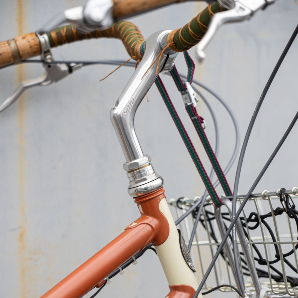 Quill stem close-up: a polished silver quill stem inserts into the fork steerer of a classic steel bike, threaded headset