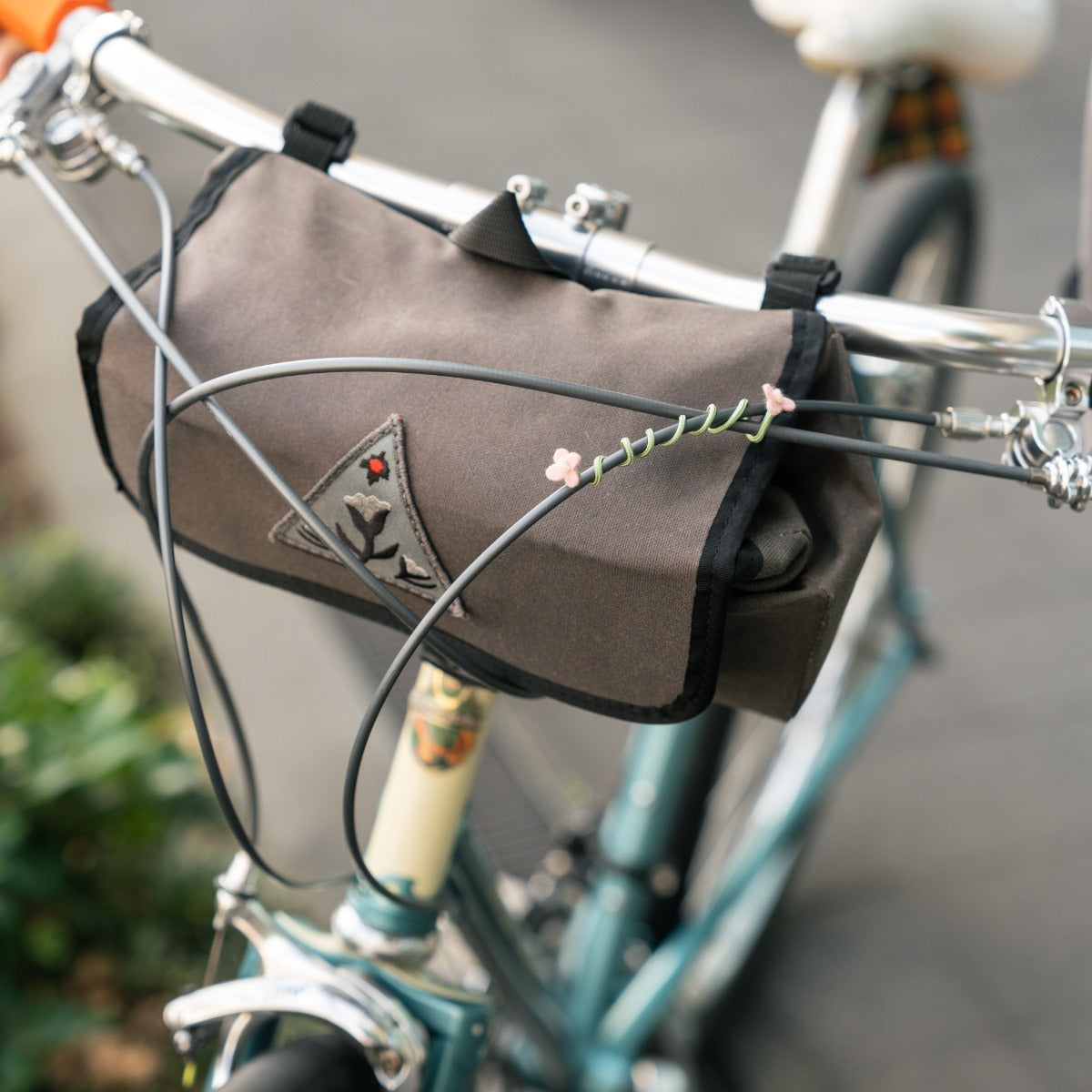 GHOOOST Twist Flower attached to a handlebar bag strap